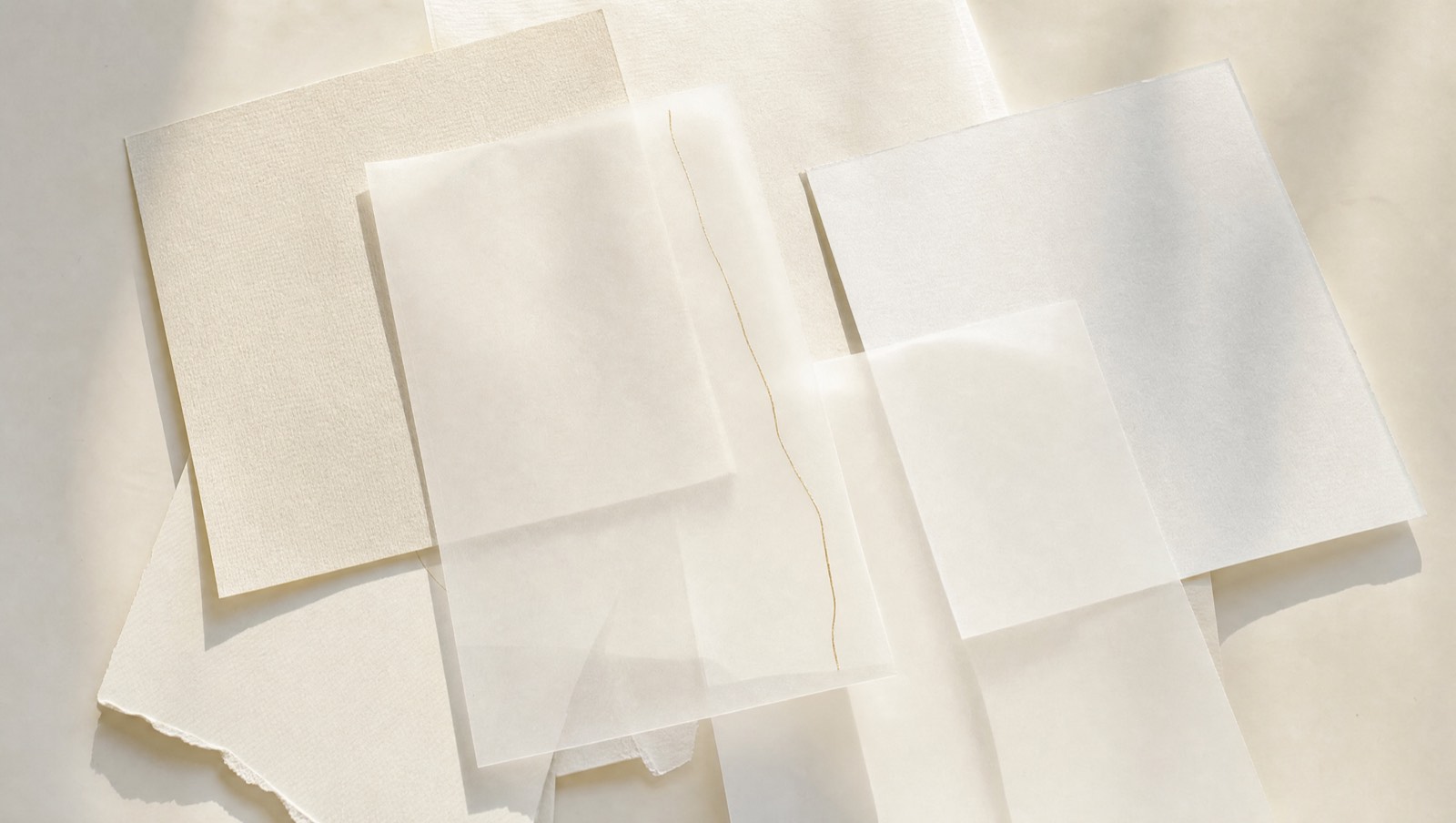 Sheets of vellum on a bone desk, one marked with a fine gold line